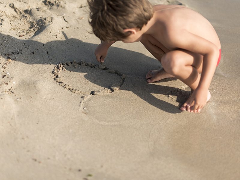 Un bébé qui joue dans le sable à la plage